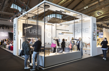 Elegant and modern glass-structured booth showcasing innovative consumer goods at  Indplas'25
, Messe Frankfurt