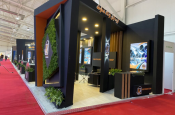 Modern industrial booth with greenery accents, highlighting innovative packaging solutions at ArabPlast 2025 in Dubai