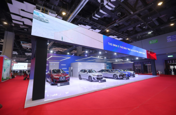 Exhibition booth displaying premium electric cars, representing cutting-edge automotive technology at Bharat Mobility Global Expo 2025