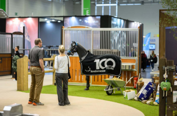 Horse-themed exhibition booth setup with visitors exploring products at Spoga Horse 2025.